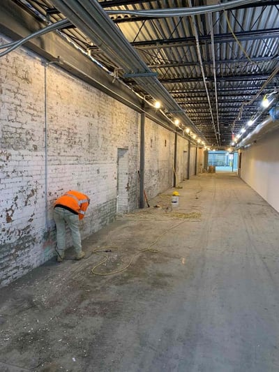 BUILDING 200- LOOKING SOUTH, PREPPING WALLS FOR FINAL FINISH IN CORRIDOR