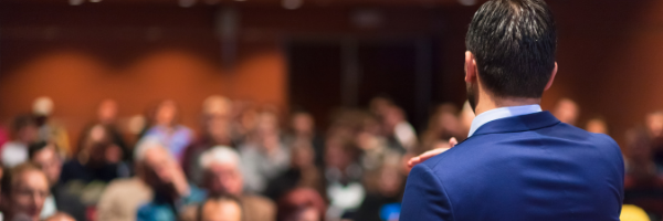 man giving speech to audience