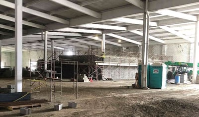 SCAFFOLDING SURROUNDING THE MASONRY WALLS THAT