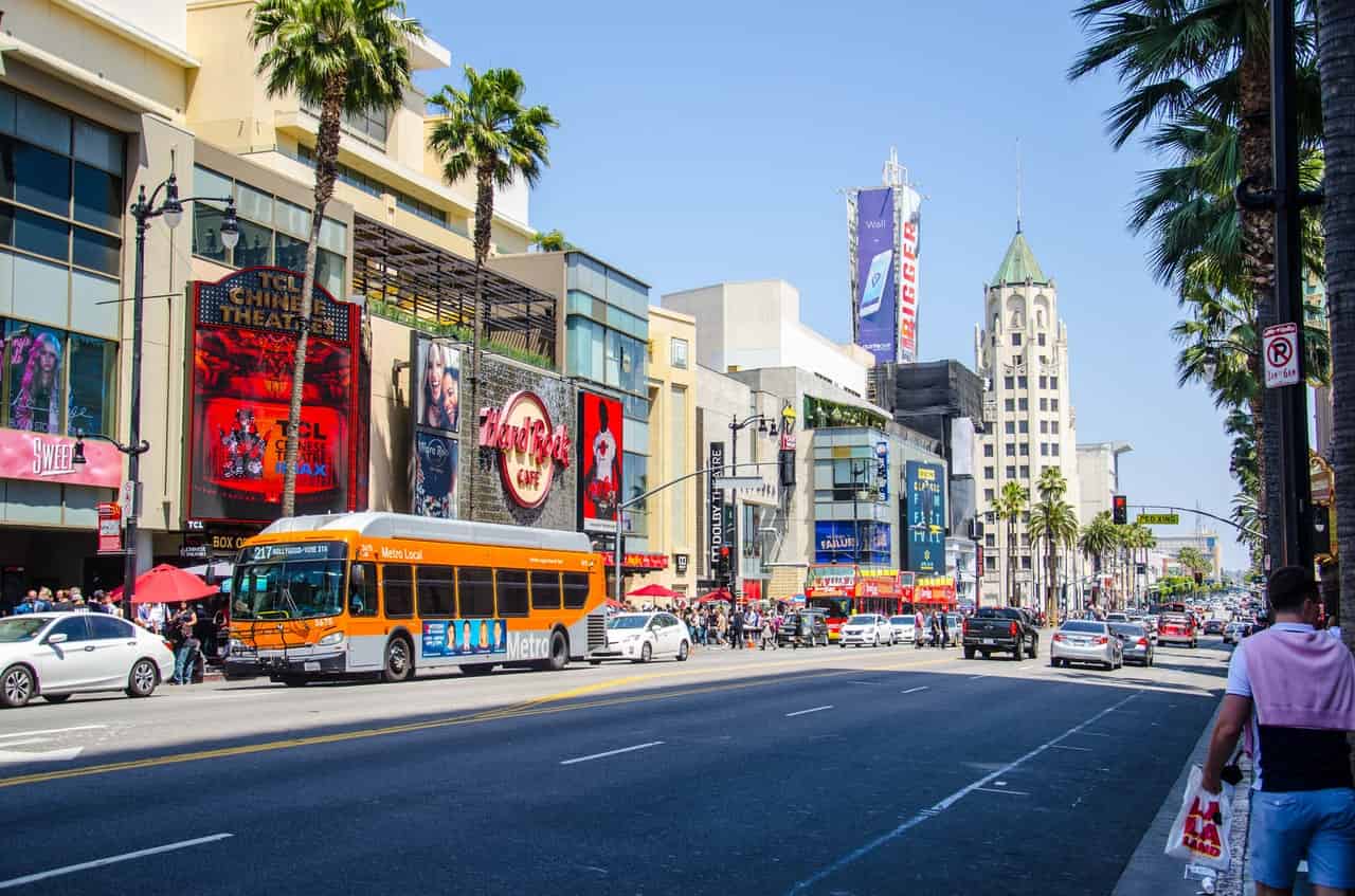 busy street with bus parked outside theater