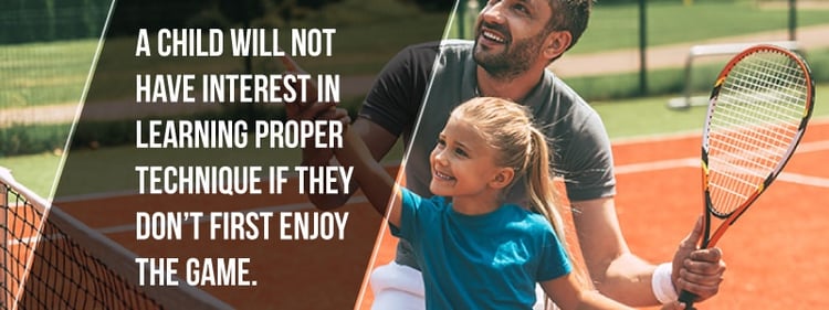 dad playing tennis with daughter