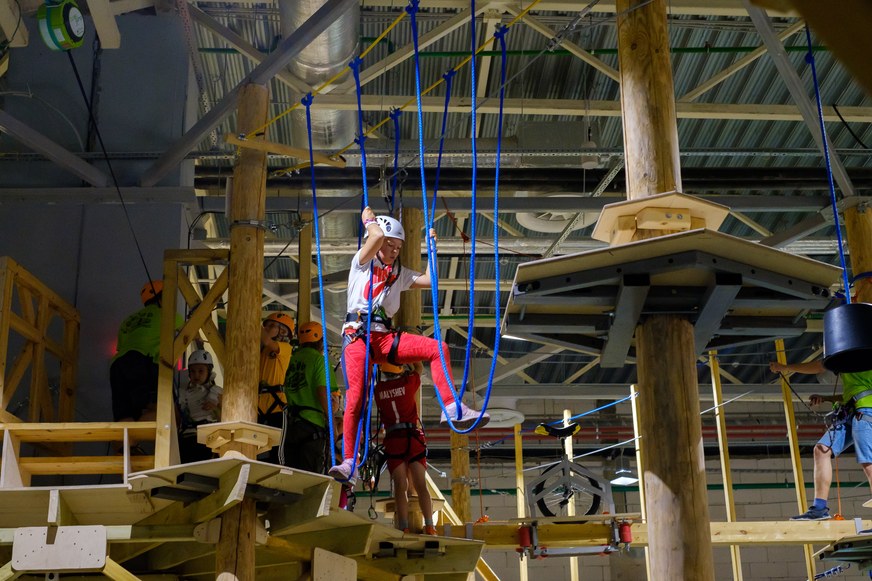 A child on a ropes course in Hamilton, Ohio, walking across ropes