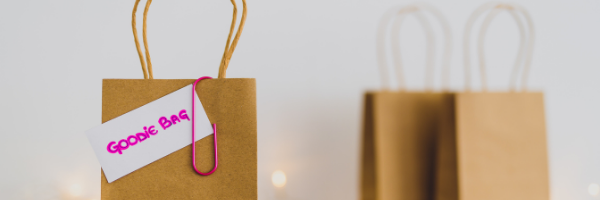 brown paper goodie bag with pink paper clip