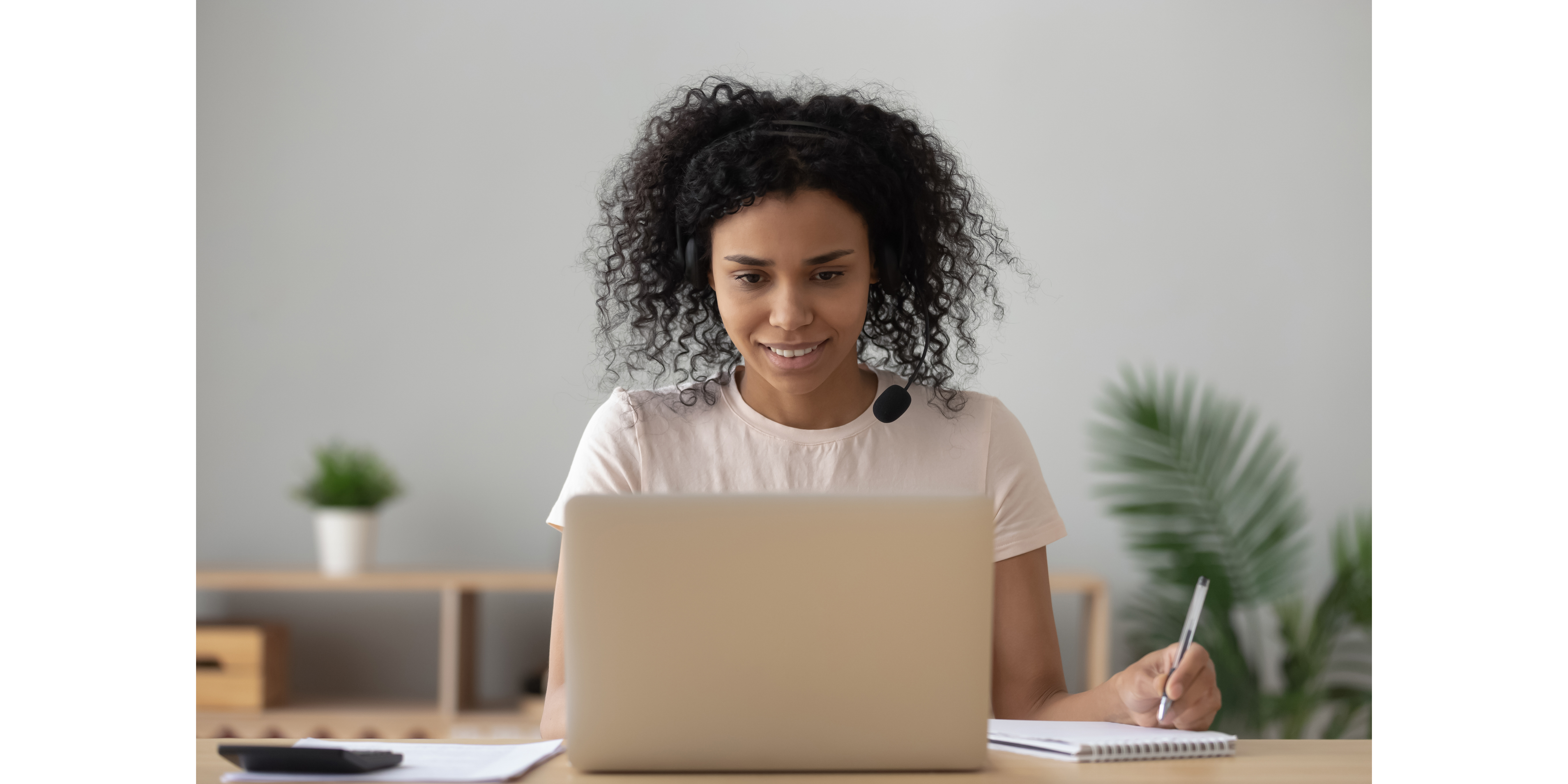 Girl in front of her computer with headset