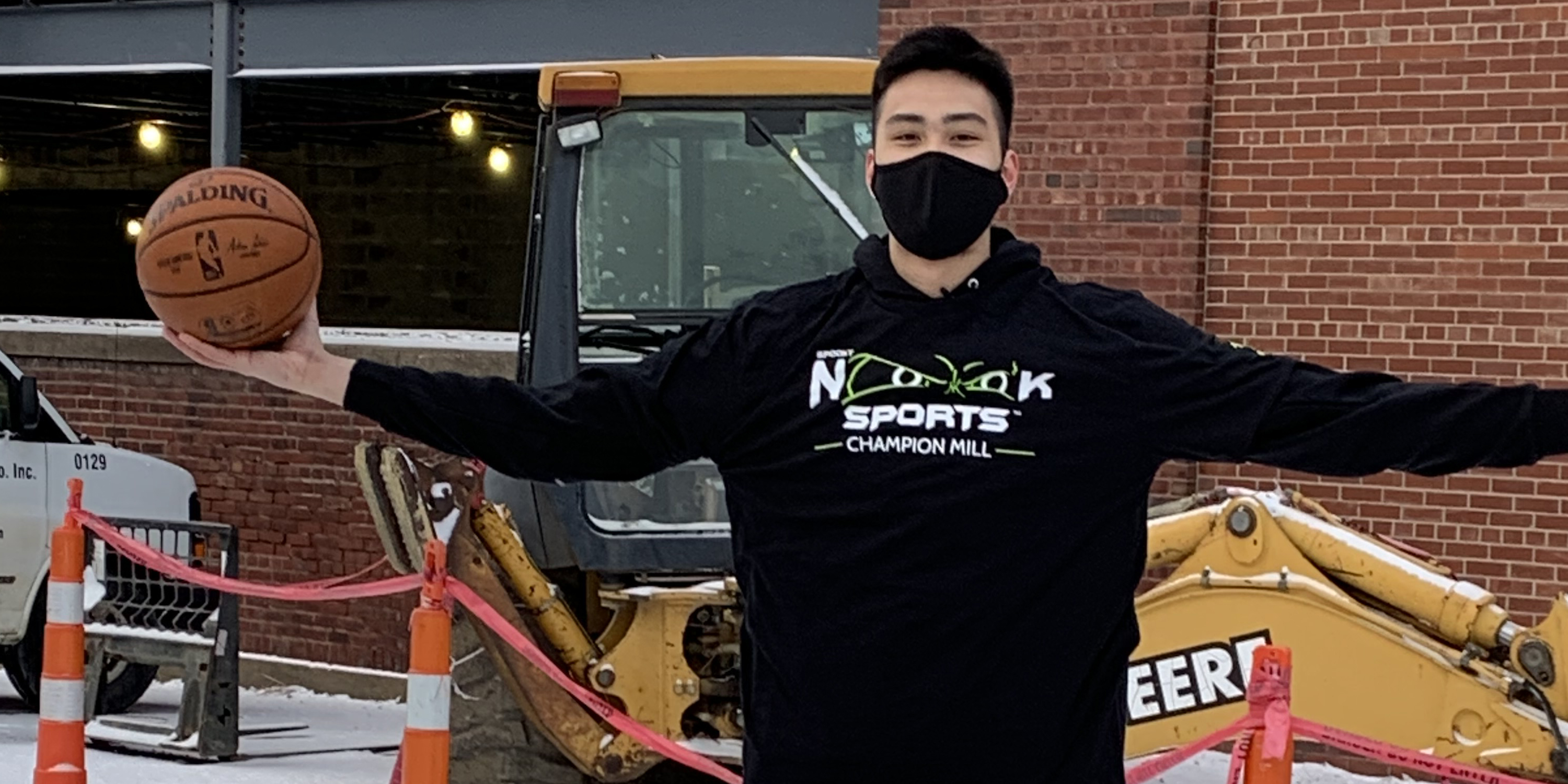 Kai holding basketball outside Nook Ohio location