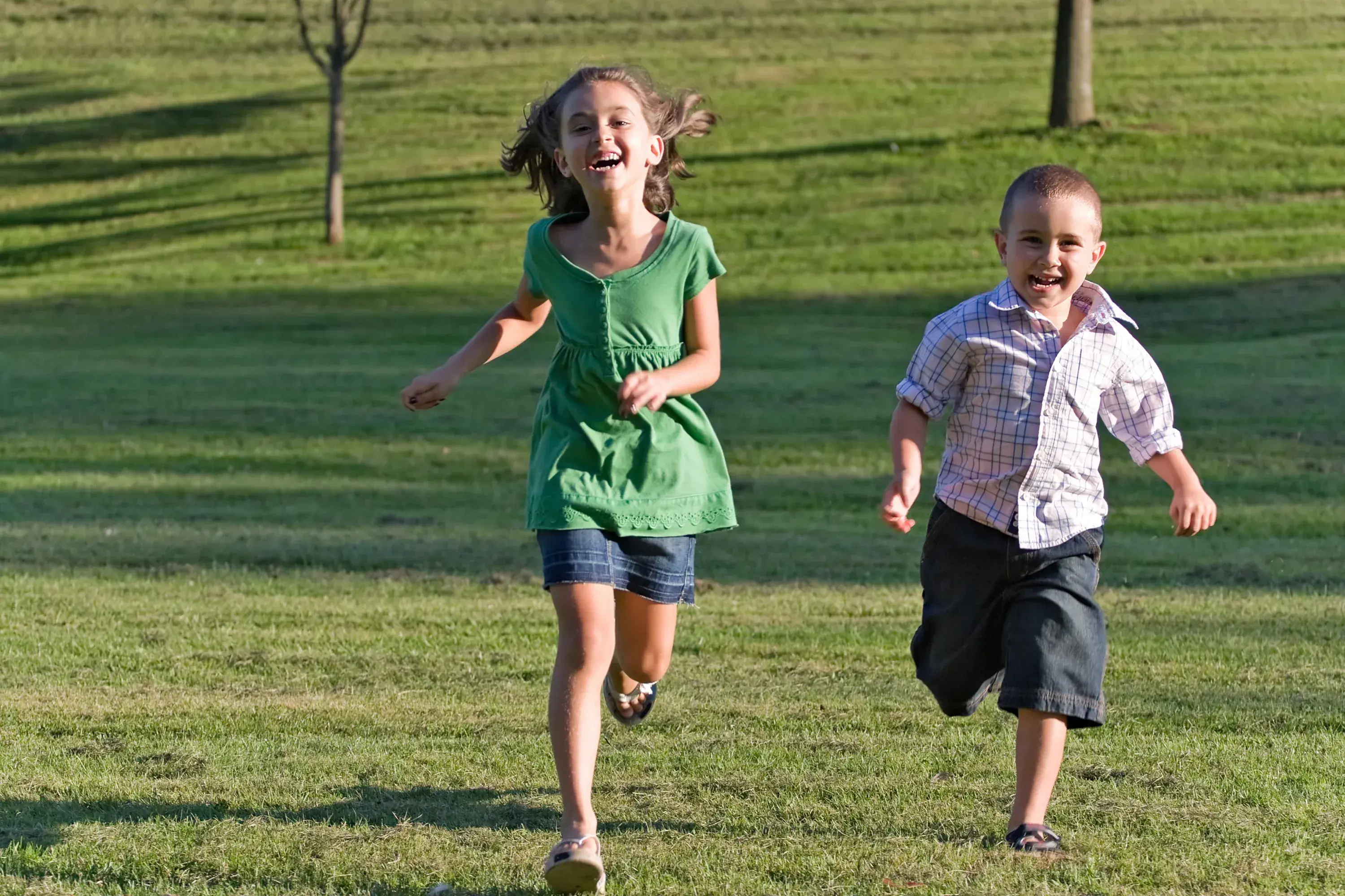https://2956241.fs1.hubspotusercontent-na1.net/hubfs/2956241/happy-kids-running-through-grassy-field%20(1).webp background-image